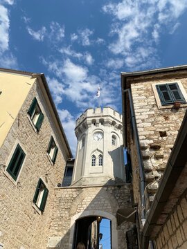 Low-angle view of the Sat Kula Clock Tower in Herceg Novi, Montenegro