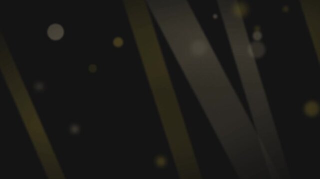 Abstract motion graphics featuring elegant golden diagonal ribbons and shimmering bokeh particles floating against a dark, sophisticated backdrop, creating a luxurious and serene atmosphere.