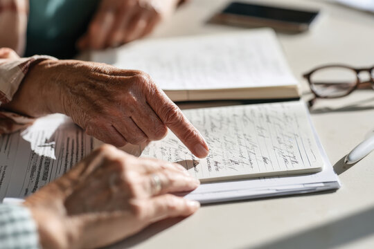 Two individuals engage in discussion while pointing at notes, highlighting collaboration and teamwork in an environment focused on learning and sharing ideas.