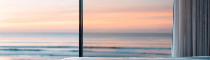 Fototapeta premium A bedroom window opens to a breathtaking view of the ocean at sunset, where gentle waves crash against the shore, reflecting the golden hues of the evening sky in a tranquil coastal setting.