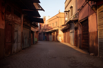 Fototapeta premium Moroccan market alleyway in old city street under warm sunlight