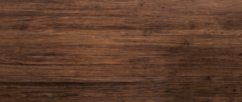 Warm brown walnut wood texture background showing rich timber grain surface with fine natural speckles for design projects
