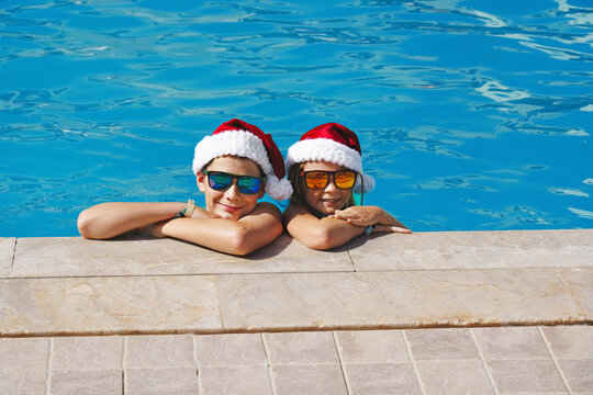 Christmas vacation on a tropical island. Children at a swimming pool at Christmas. Real people, not AI.