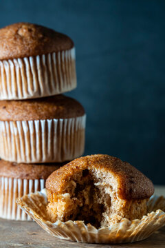 Carrot cake muffins in paper liners on a wood surface 