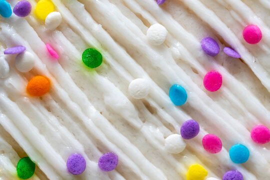 Close up of white frosting and sprinkles 