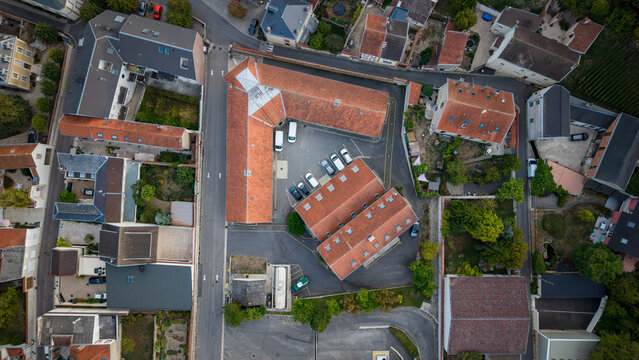 Aerial view of village houses with tiled roofs and courtyards
