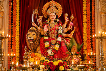 Fototapeta premium Radiant Goddess Durga Idol Decorated with Flowers and Glowing Diyas for Navratri Celebration