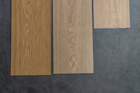 Laminate flooring samples arranged on a grey background