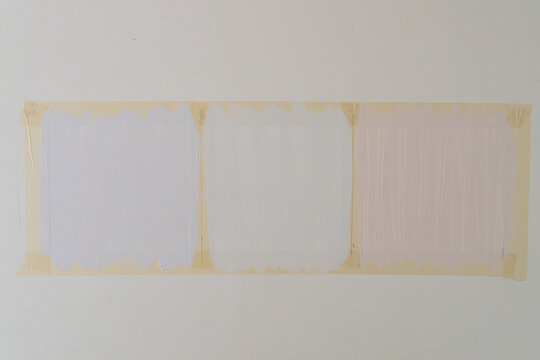 White wall with masking tape marking paint sample panels