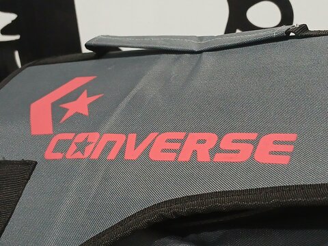 Wonosobo, Indonesia - 5 October 2025: Converse logo printed in red on gray fabric bag with black trim and carry handle.