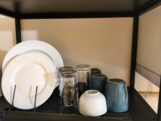 Hotel or restaurant tableware arranged on a serving tray, featuring plates, drinking glasses and...
