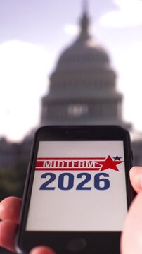 Online voting in the US midterm elections: a smartphone with the Capitol building in the background.