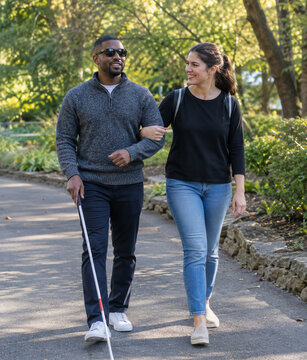 Sighted Guide Technique Demonstrated by Companions on Outdoor Walk