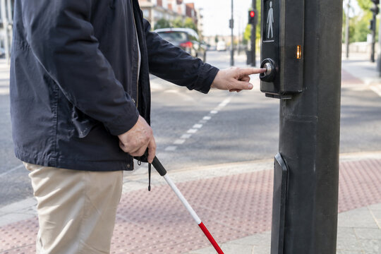 Pedestrian Operating Tactile and Audible Push Button at Street Crossing
