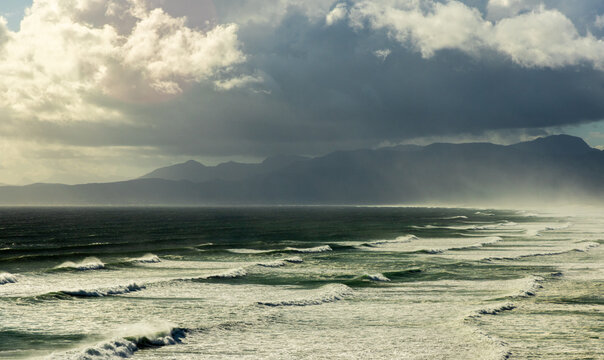 aerial view of massive wave sets rolling into Walker Bay Nature Reserve, South Africa 