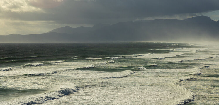 aerial view of massive wave sets rolling into Walker Bay Nature Reserve, South Africa 