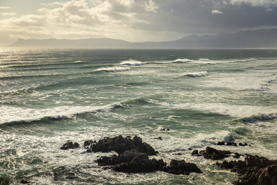 aerial view of massive wave sets rolling into Walker Bay Nature Reserve, South Africa 