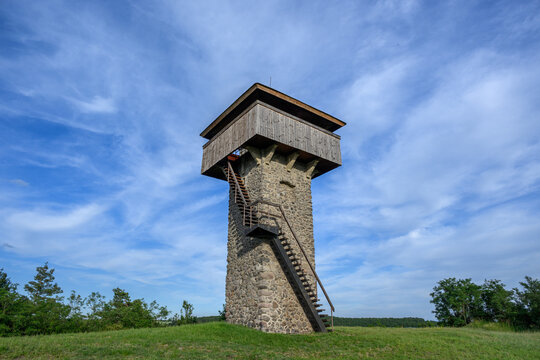 Wispy summer clouds drifting above the Vartovka watchtower near Krupina, Slovakia
