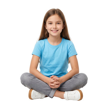 Smiling young girl sitting cross-legged in a blue t-shirt, isolated on black