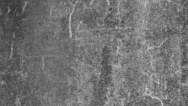 Dark aged concrete wall featuring vertical weathering marks, fine scratches and layered tonal variation in black and white.