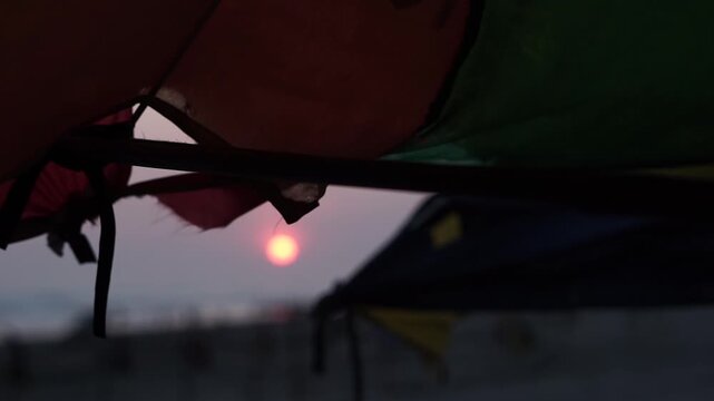 Stunning Sunset at Parangtritis Beach, Yogyakarta - Silhouetted Tent View of Golden Sun and Dramatic Sky