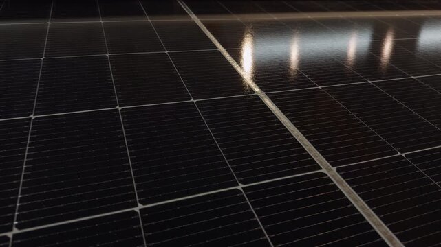 Solar Panels Reflect Overhead Light in a Close Oblique View, Showing Photovoltaic Cells and Clean Renewable Energy Technology