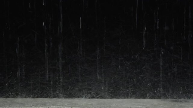 Heavy Rain Falls on Wet Pavement at Night, Creating a Dark Dramatic Outdoor Weather Background With Visible Water Streaks