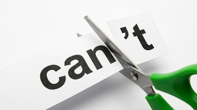 Concept of achieving goals shown by green scissors cutting can't into can and t on white paper.