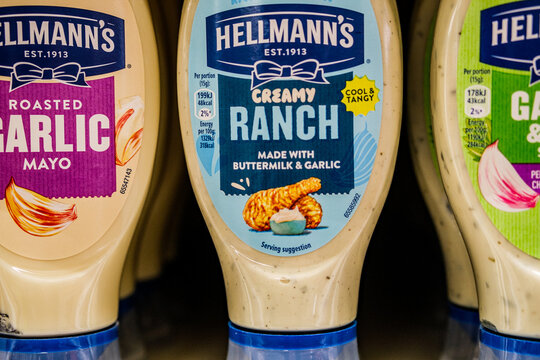Close-Up Of A row Of Hellmann's Squeeze Bottles Of Creamy Ranch And Roasted Garlic Mayonnaise