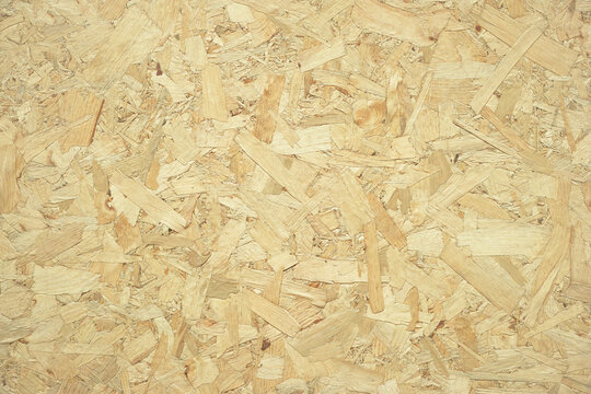 Oriented strand board texture featuring raw timber flakes for construction and industrial design use