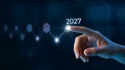 Obraz premium Person touching virtual futuristic screen displaying year 2027 future growth