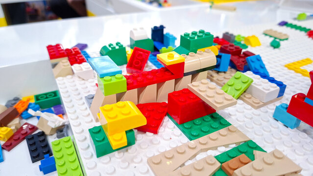 Colorful lego plastic interlocking building blocks and toy bricks constructed on a white baseplate during children play activity on September 22, 2026 in Bangkok, Thailand.