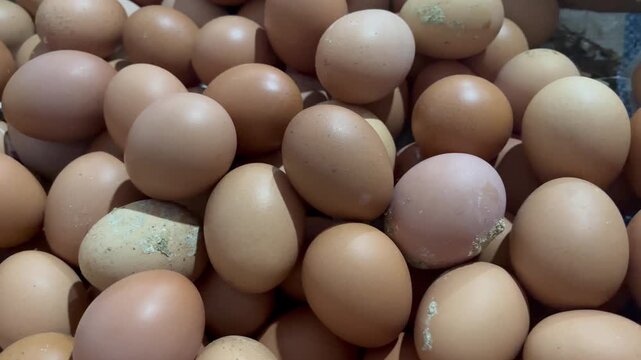 Fresh raw chicken eggs stacked in local traditional market stall