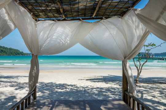 Canopy bed on the beach, resort at Saracen Bay on the island of Koh Rong Sanloem, Cambodia