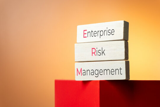 White wooden blocks reading Enterprise Risk Management or ERM. Corporate governance, business security, and threat mitigation concept.