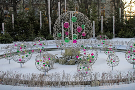 Christmas Ornamens in Fountain Covered With Snow in Paris France Winter Celebration