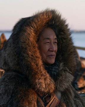 Focused Scientist in Arctic Gear Conducting Field Research Amidst Snowy Landscape