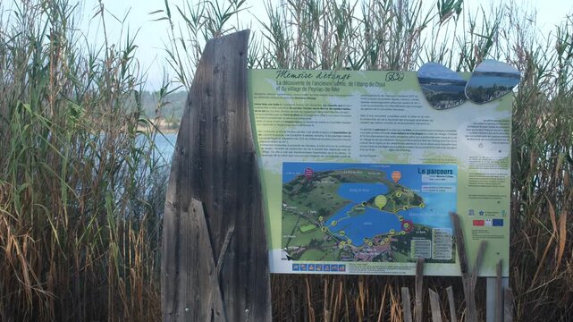 Peyriac-de-Mer, Occitanie, France. August 27, 2026. Signpost on walking route "Memory of the lagoons," through salt marshes, old hydraulic structures, places connected to the history of salt mining.
