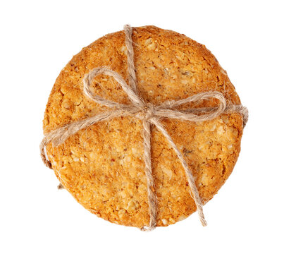 Round cookie tied with twine resting on a white backdrop