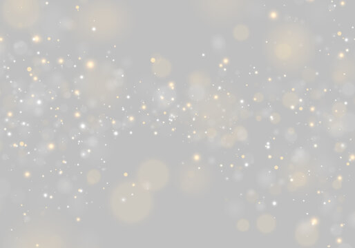 Soft glowing orbs float across a dark background in scattered golden and silver hues. The bokeh effect presents varying sizes with smooth edges and diffused light.