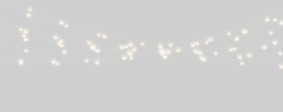 A series of small glowing lanterns hanging in the night. The lanterns emit a soft, warm golden light with a slight haze around each bulb. This image works well for themes of festivity.