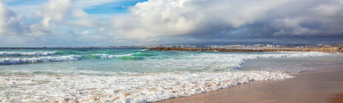Seacoast of Costa da Caparica city. View of Lisbon fron Costa da Caparica beach. Almada, Portugal