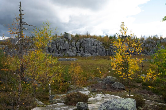Granite cliff under a dark, dramatic sky.