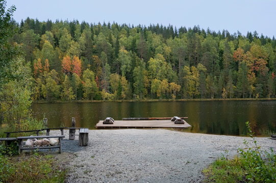 A wooden dock extends into a serene lake