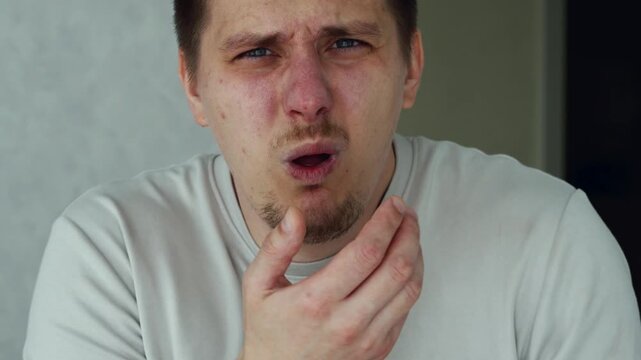 The man is bothered by a cough.
Sore throat due to tonsillitis.