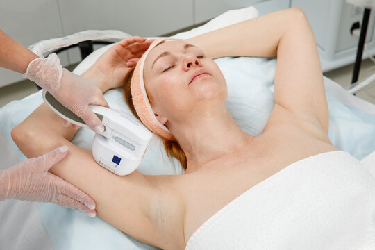 Aesthetician Performing Cosmetic Treatment on Woman in Modern Beauty Clinic
