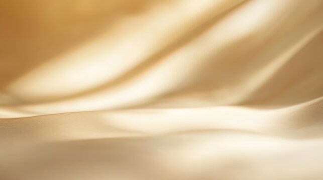 Soft golden silk fabric draped in elegant waves with smooth texture and warm natural lighting