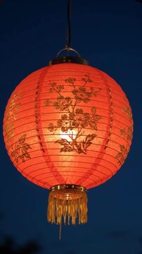 Red paper lantern swaying close in night breeze