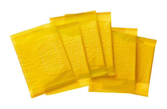 Yellow condom packets stacked on top of each other showing front and back sides