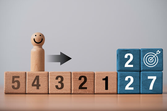 Happy person follows countdown toward 2027 target representing goal achievement, motivation progress and success planning with copy space for business, career and personal development concepts.